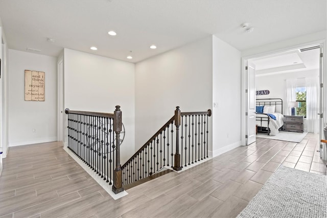 5823 Title Row Dr, Bradenton, FL 34210 - corridor featuring an upstairs landing, wood tiled floors, and recessed lighting