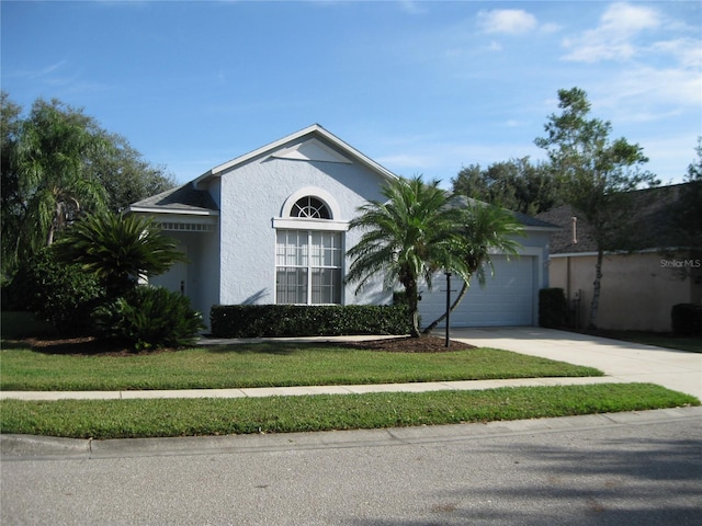 12301 Mosswood Pl, Lakewood Ranch, FL 34202 - view of front of house with concrete driveway, an attached garage, and stucco siding