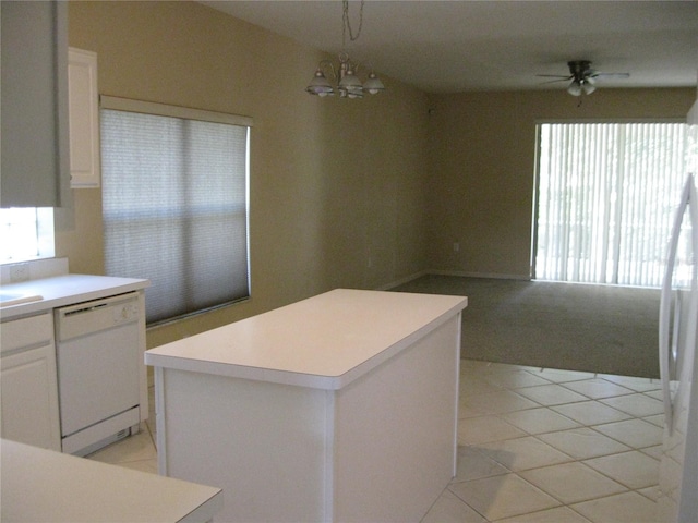 12301 Mosswood Pl, Lakewood Ranch, FL 34202 - kitchen featuring white appliances, light countertops, a kitchen island, light carpet, and a chandelier