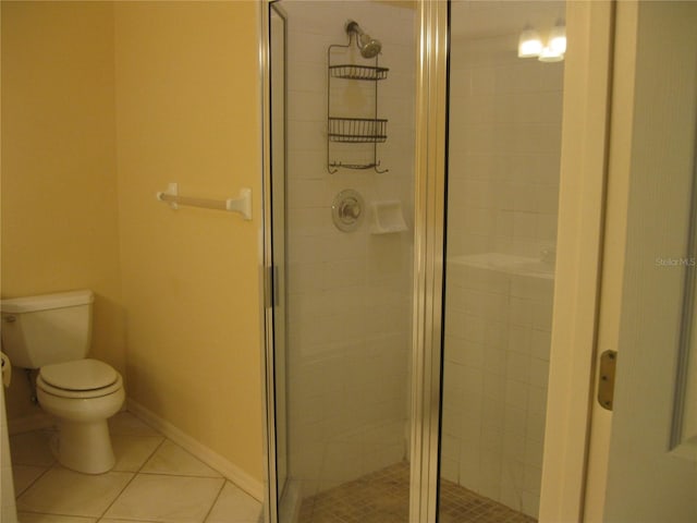 12301 Mosswood Pl, Lakewood Ranch, FL 34202 - bathroom featuring a stall shower, tile patterned floors, and toilet