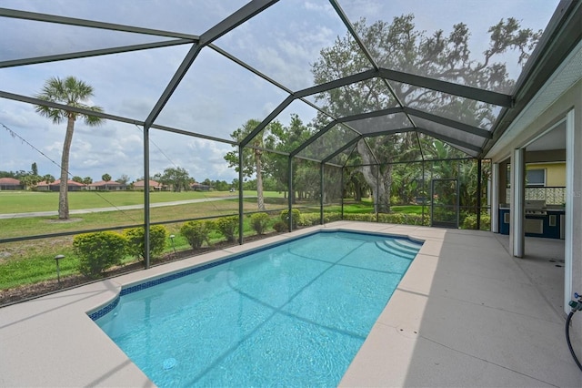 swimming pool featuring a patio, a lanai, and a yard