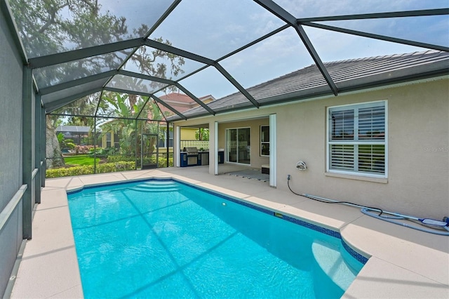outdoor pool featuring a patio area and a grill