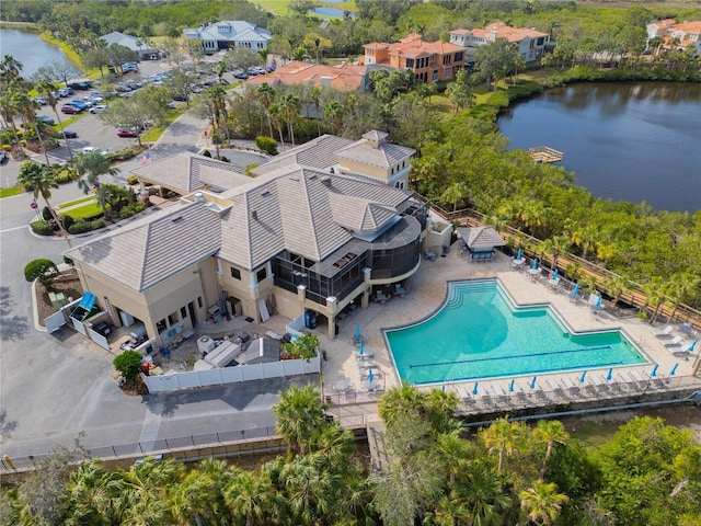 bird's eye view of a pool area and a nearby body of water