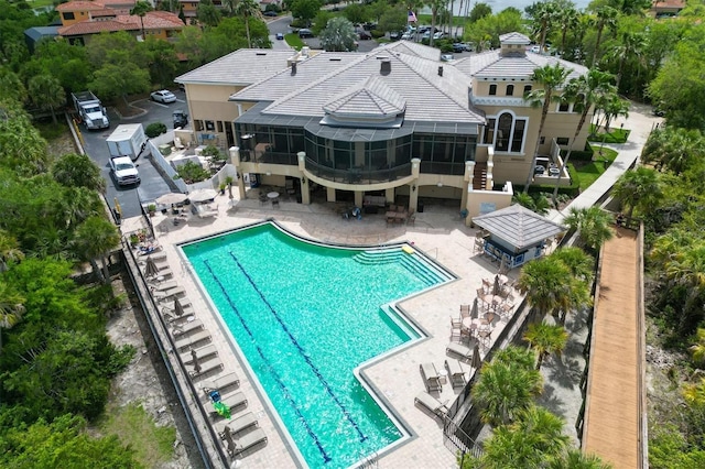 community pool with a patio and a sunroom
