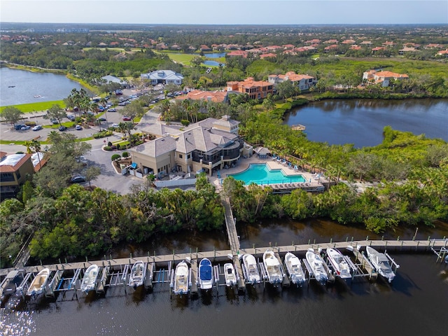aerial view of property's location featuring a large body of water and a pool