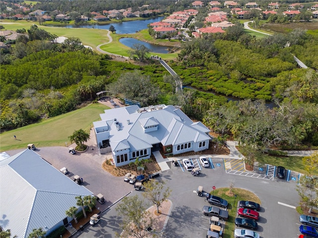 aerial view of residential area featuring a local golf course and a nearby body of water