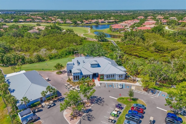 aerial view of residential area featuring a golf club and a nearby body of water