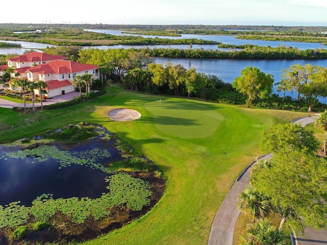 bird's eye view of a golf course and a nearby body of water