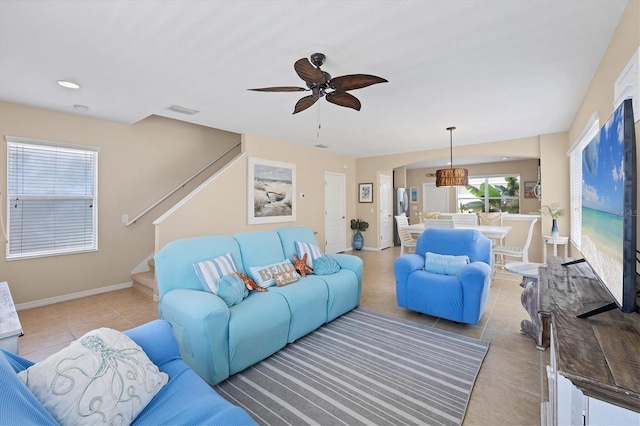 4811 Woodbrook Dr, Sarasota, FL 34243 - living area with light tile patterned flooring, ceiling fan, and stairway