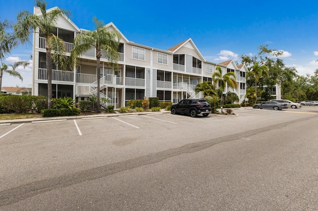 view of apartment building / complex featuring uncovered parking