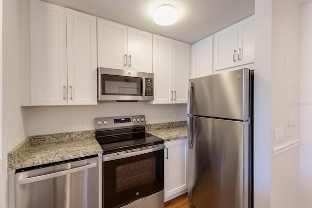 kitchen with appliances with stainless steel finishes and white cabinets