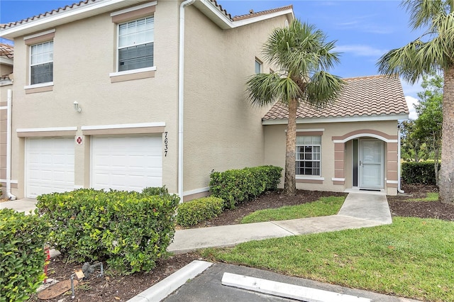 7637 Sweetbay Cir, Bradenton, FL 34203 - view of front facade with a tile roof, stucco siding, a garage, and uncovered parking