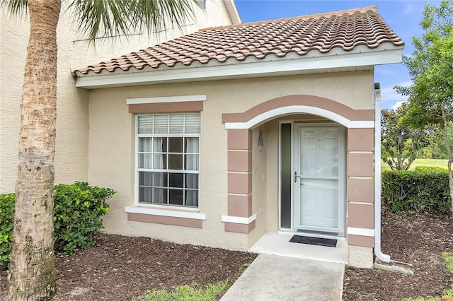 7637 Sweetbay Cir, Bradenton, FL 34203 - view of exterior entry with stucco siding and a tile roof