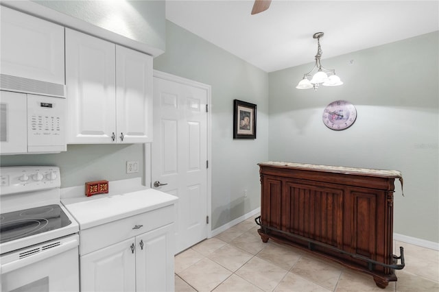 7637 Sweetbay Cir, Bradenton, FL 34203 - kitchen featuring white appliances, white cabinets, light countertops, pendant lighting, and baseboards