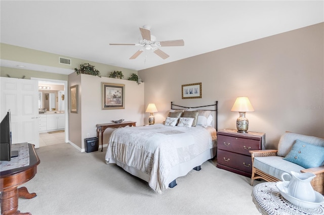 7637 Sweetbay Cir, Bradenton, FL 34203 - bedroom featuring light carpet, baseboards, connected bathroom, and a ceiling fan