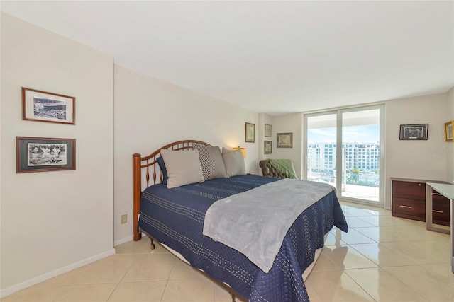 101 S Gulfstream Ave Unit 16C, Sarasota, FL 34236 - bedroom featuring access to outside, light tile patterned flooring, and baseboards