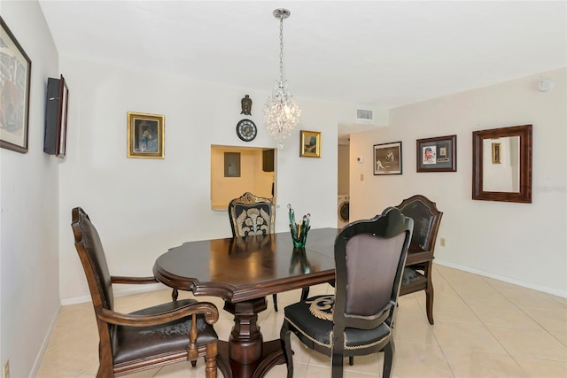 101 S Gulfstream Ave Unit 16C, Sarasota, FL 34236 - dining space featuring a chandelier, light tile patterned floors, and baseboards