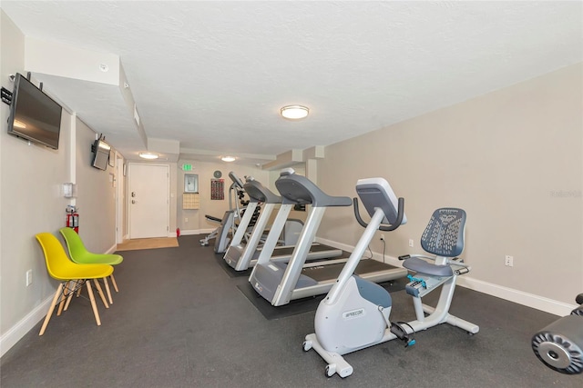101 S Gulfstream Ave Unit 16C, Sarasota, FL 34236 - exercise area featuring baseboards and a textured ceiling