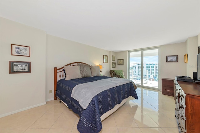 101 S Gulfstream Ave Unit 16C, Sarasota, FL 34236 - bedroom featuring floor to ceiling windows, access to outside, light tile patterned flooring, and baseboards