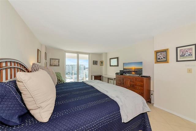101 S Gulfstream Ave Unit 16C, Sarasota, FL 34236 - bedroom featuring light tile patterned floors, baseboards, and access to exterior