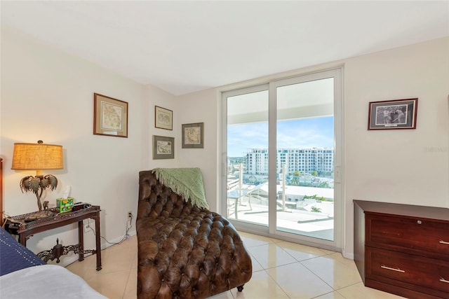 101 S Gulfstream Ave Unit 16C, Sarasota, FL 34236 - bedroom featuring access to outside, light tile patterned floors, and baseboards