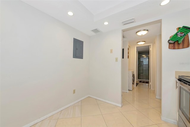 101 S Gulfstream Ave Unit 16C, Sarasota, FL 34236 - corridor with electric panel, washing machine and clothes dryer, recessed lighting, baseboards, and light tile patterned floors