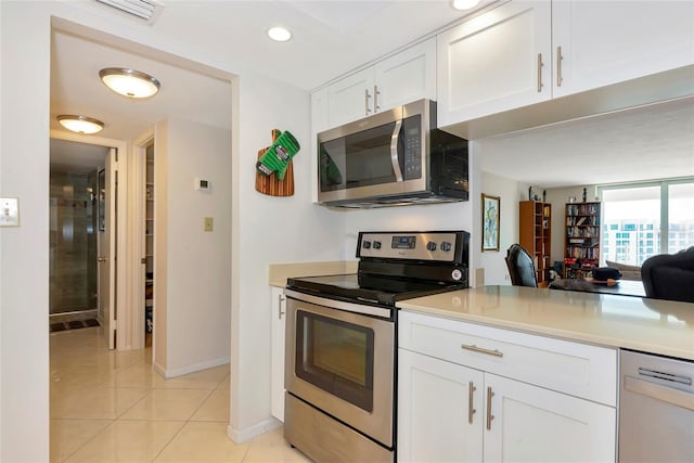 101 S Gulfstream Ave Unit 16C, Sarasota, FL 34236 - kitchen featuring stainless steel appliances, white cabinetry, light tile patterned floors, baseboards, and light countertops