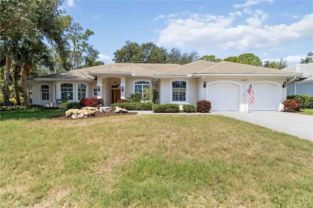 2067 Tocobaga Ln, Nokomis, FL 34275 - ranch-style home featuring a garage, driveway, stucco siding, and a front lawn