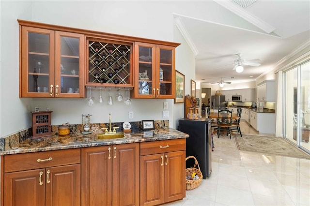 2067 Tocobaga Ln, Nokomis, FL 34275 - indoor wet bar featuring ornamental molding, stainless steel appliances, a ceiling fan, and light tile patterned floors