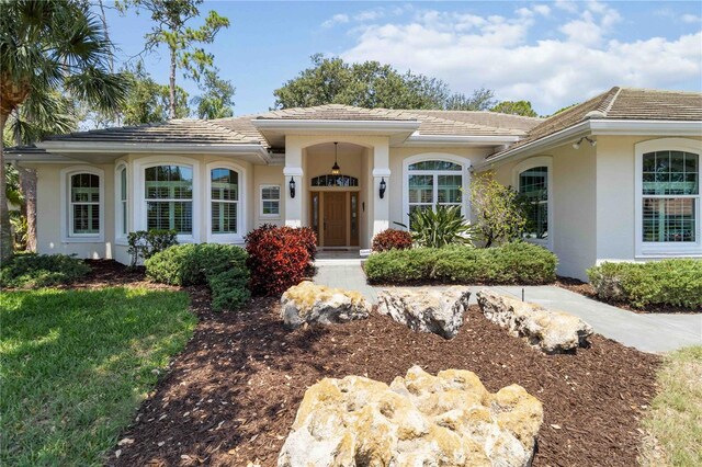 2067 Tocobaga Ln, Nokomis, FL 34275 - view of front of property featuring stucco siding and a tiled roof