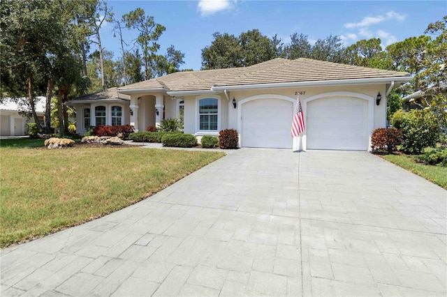 2067 Tocobaga Ln, Nokomis, FL 34275 - single story home with a garage, a front lawn, concrete driveway, a tiled roof, and stucco siding