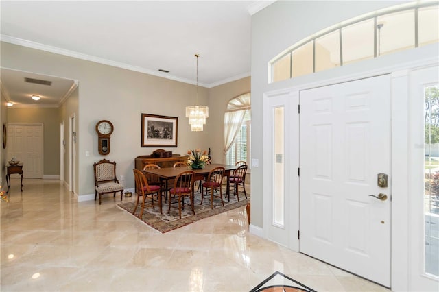 2067 Tocobaga Ln, Nokomis, FL 34275 - entrance foyer with light marble finish flooring, a chandelier, crown molding, and baseboards