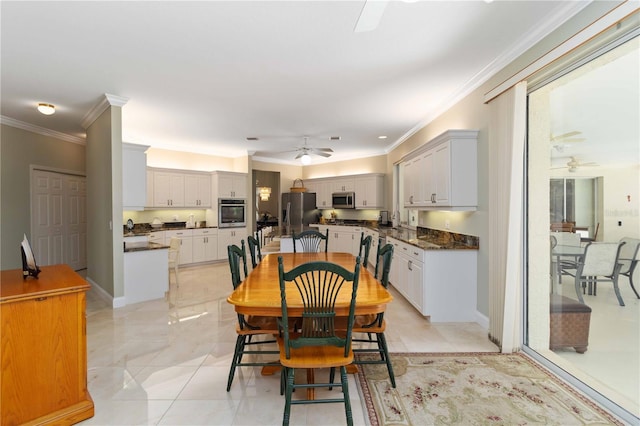 2067 Tocobaga Ln, Nokomis, FL 34275 - dining area featuring a ceiling fan and crown molding