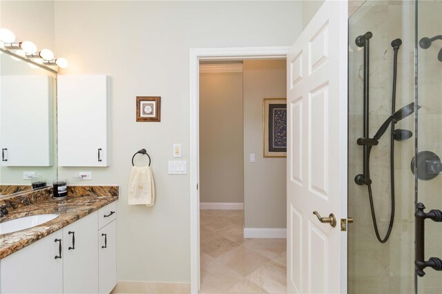 2067 Tocobaga Ln, Nokomis, FL 34275 - bathroom featuring vanity, a tile shower, and baseboards
