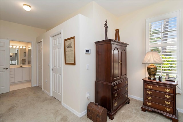 2067 Tocobaga Ln, Nokomis, FL 34275 - bedroom featuring light colored carpet, ensuite bath, and baseboards