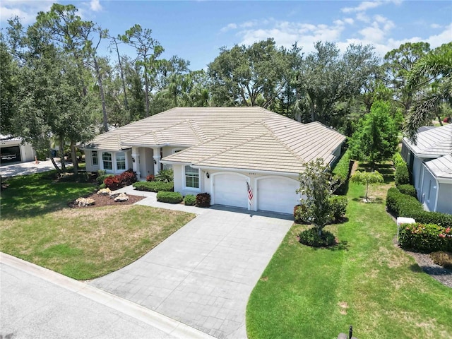 2067 Tocobaga Ln, Nokomis, FL 34275 - ranch-style home with concrete driveway, an attached garage, a tile roof, and a front yard