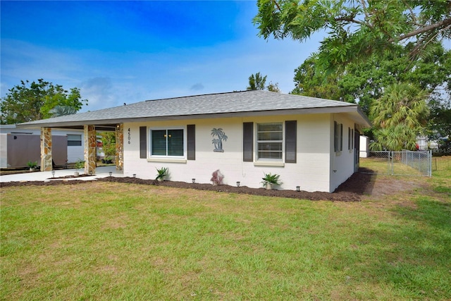 ranch-style house featuring roof with shingles and concrete block siding