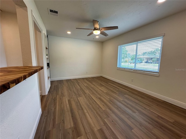 empty room featuring ceiling fan, dark wood-style floors, recessed lighting, and baseboards