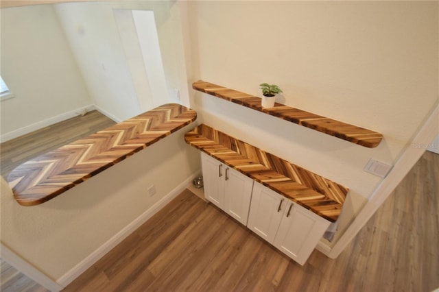 stairway with baseboards and wood finished floors