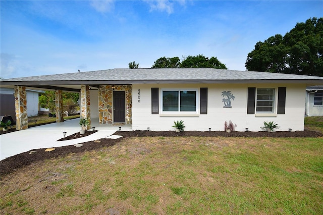 ranch-style home featuring a carport, driveway, a front lawn, and a shingled roof