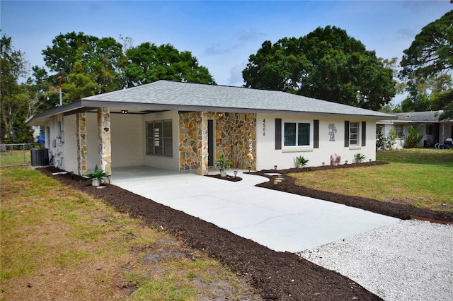 single story home with concrete driveway, cooling unit, an attached carport, and roof with shingles