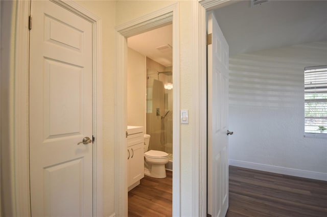 full bathroom with a shower stall, wood finished floors, toilet, vanity, and baseboards
