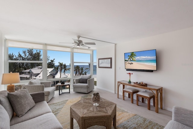 5200 Gulf Dr Unit 408, Holmes Beach, FL 34217 - living area with ceiling fan, expansive windows, and baseboards