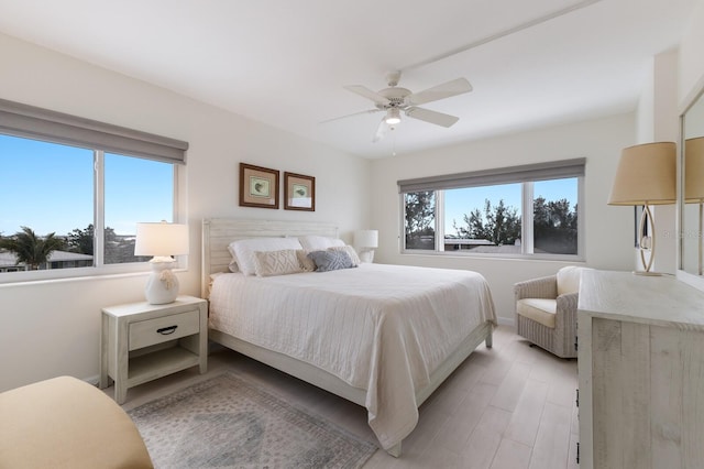5200 Gulf Dr Unit 408, Holmes Beach, FL 34217 - bedroom with light wood finished floors, baseboards, and ceiling fan