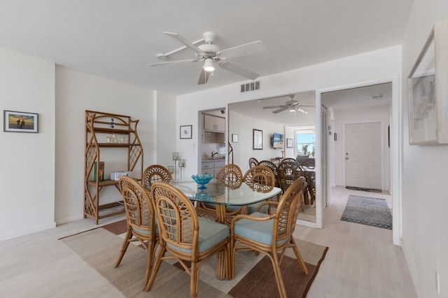 5200 Gulf Dr Unit 408, Holmes Beach, FL 34217 - dining space with a ceiling fan, light wood-style flooring, and baseboards