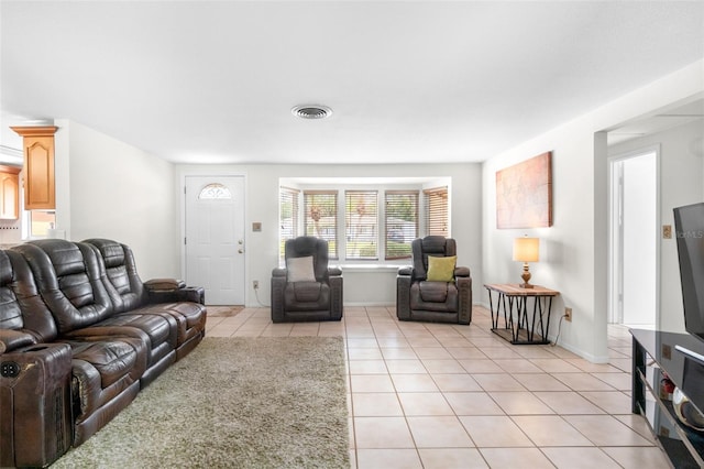 living area with light tile patterned floors and baseboards