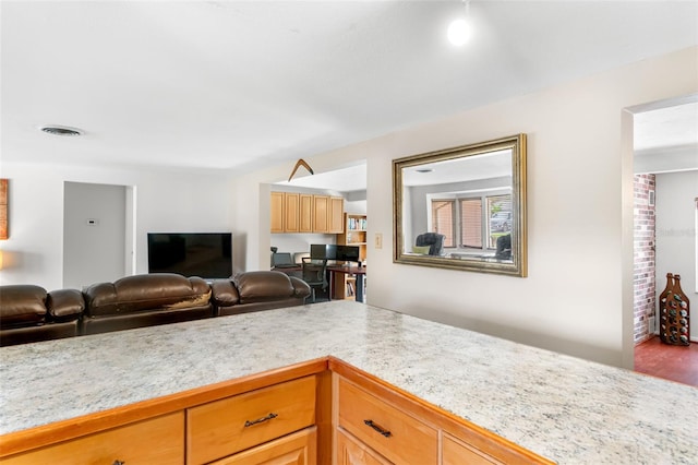 kitchen with light countertops, open floor plan, and wood finished floors