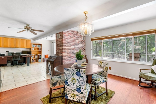 dining room with light wood-style flooring, a ceiling fan, a chandelier, beam ceiling, and baseboards