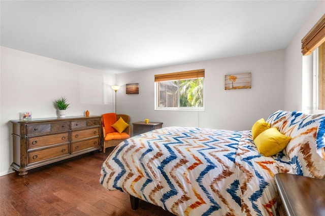 bedroom with dark wood-type flooring