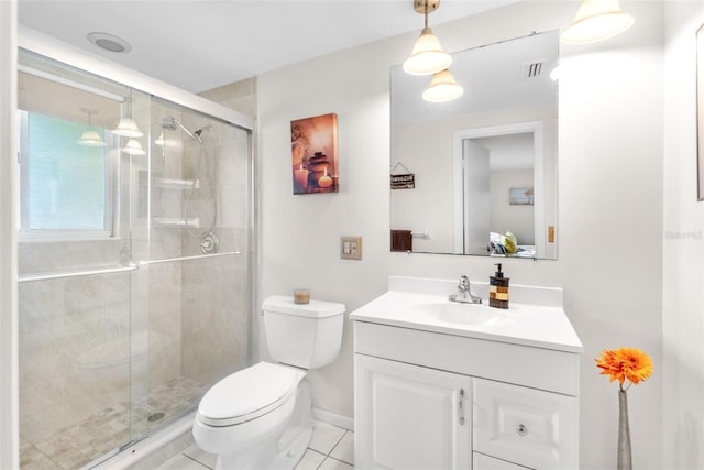 bathroom with toilet, vanity, a shower stall, and tile patterned floors